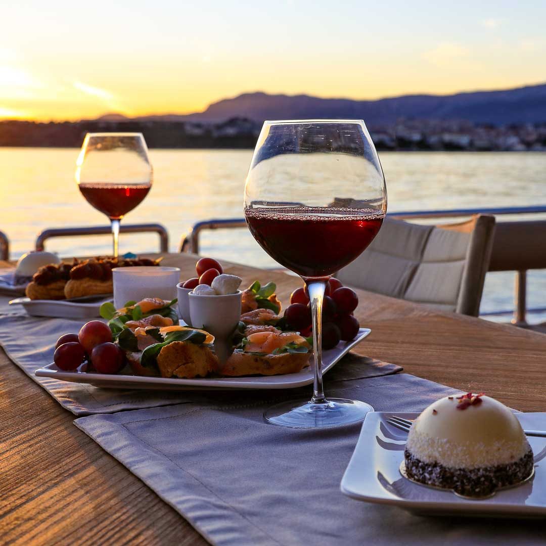 yacht dining experience Canapes on the table with glasses of wine