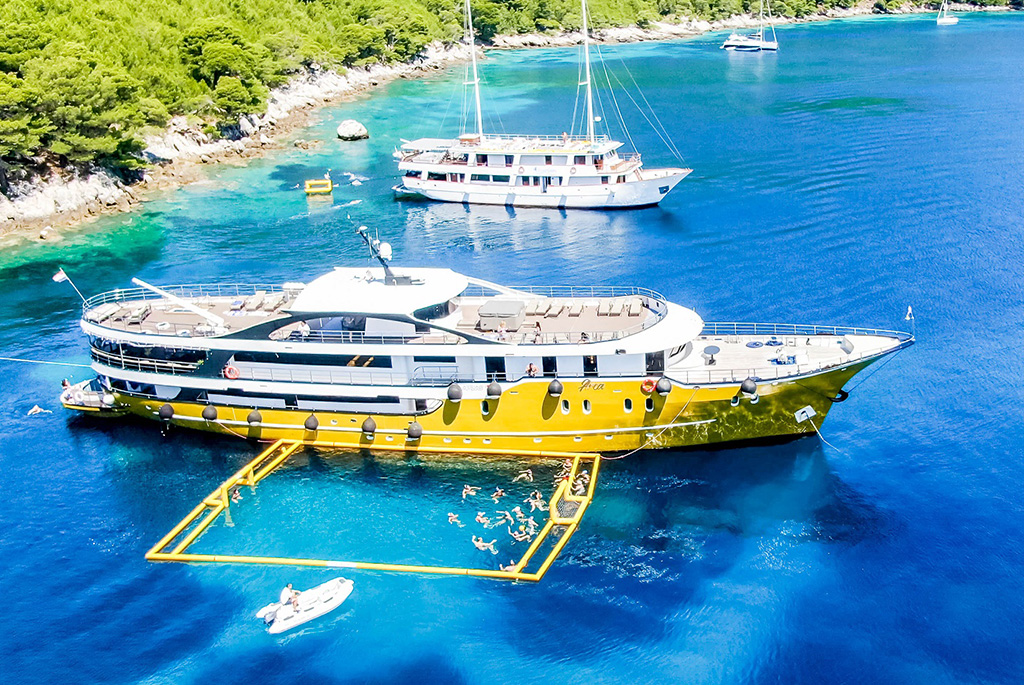 people are playing water polo next to the family yacht charter in Croatia