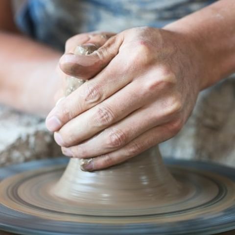 Hands shaping clay