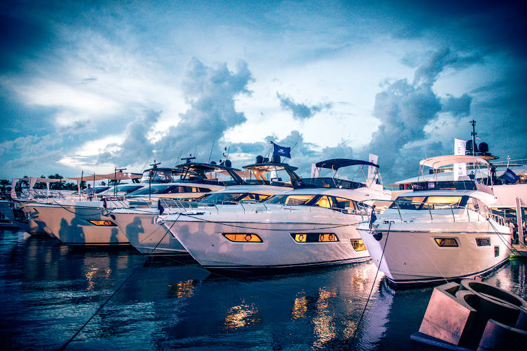 fleet of ferretti yachts moored