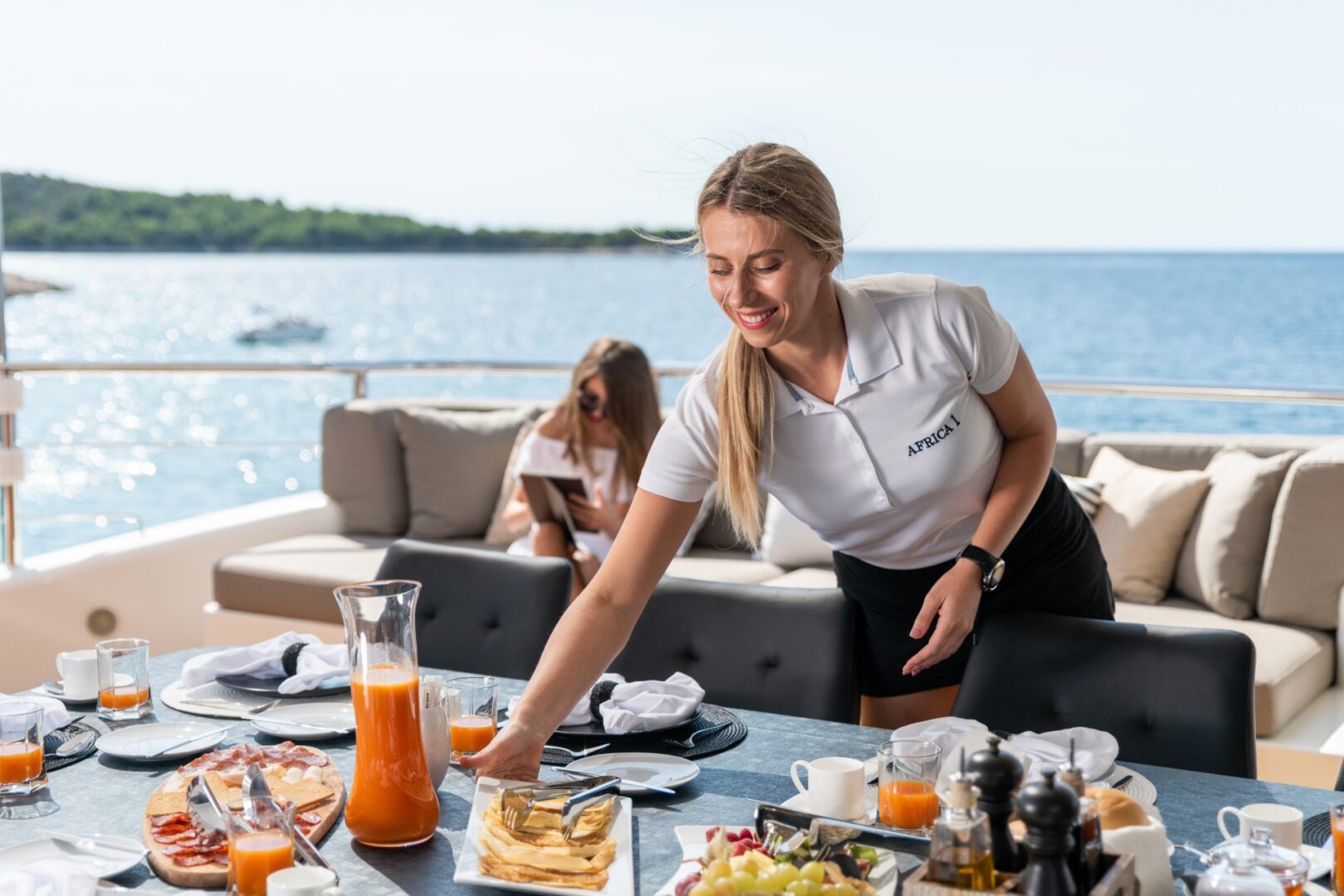 crew member setting the table for lunch