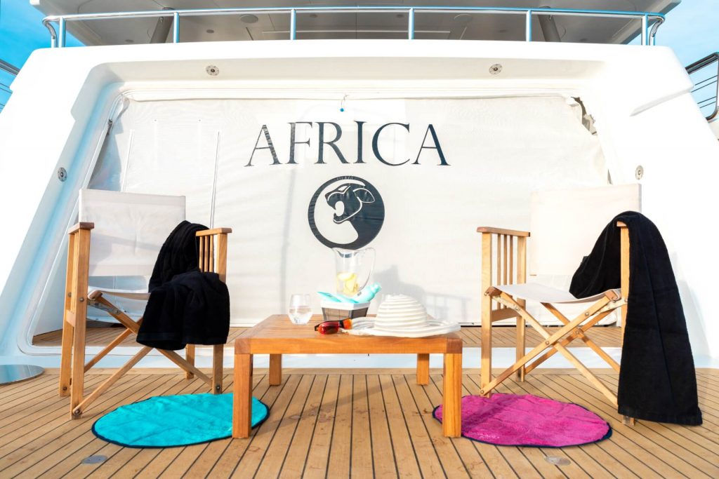 africa I yacht charter beach club two chairs an a small table