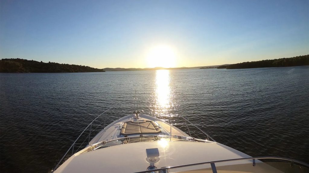 Cardano yacht charter front deck sunset