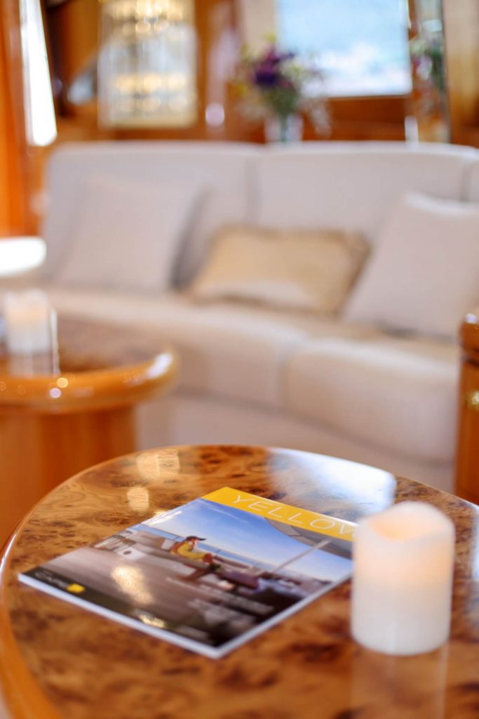 lady marcelle yacht charter coffee table with a magazine on