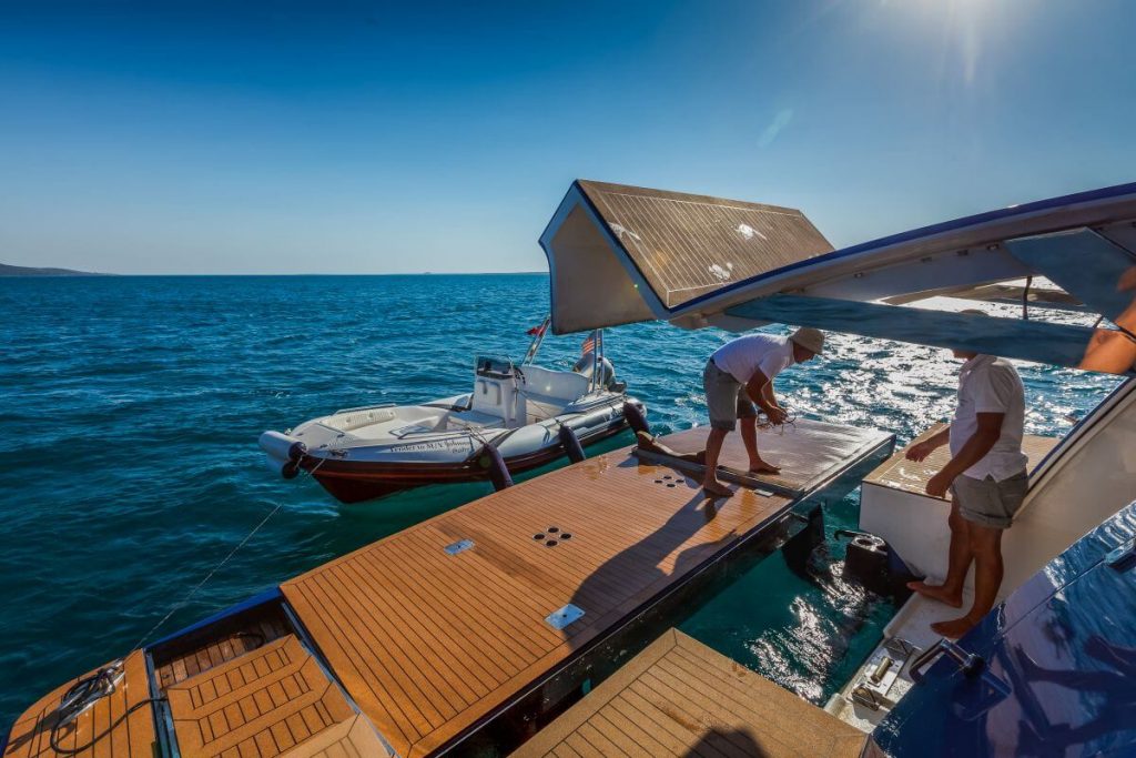 johnson baby yacht charter crew is working on the deck