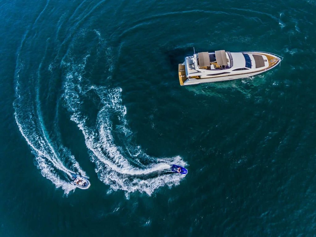 quo vadis yacht charter jetski around a yacht