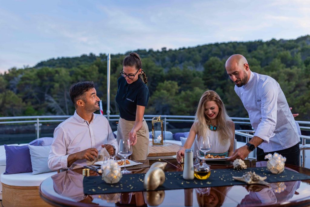 Novela yacht charter eating dinner on the sundeck