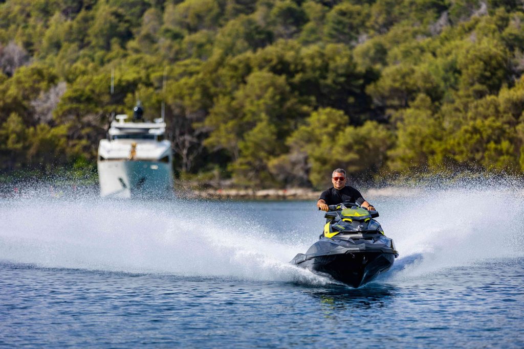 Novela yacht charter riding a jet ski