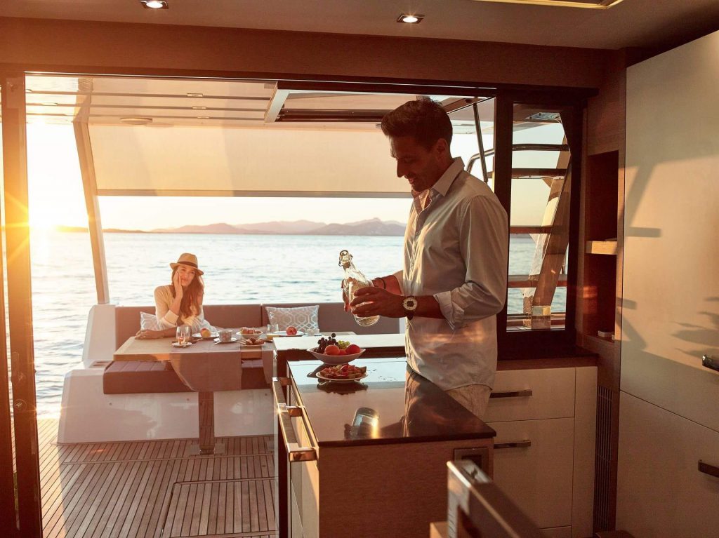 man preparing a drink in a yacht charter bar