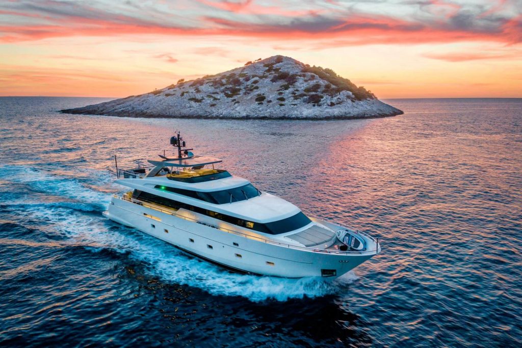 casa yacht charter sailing during sunset by the small island