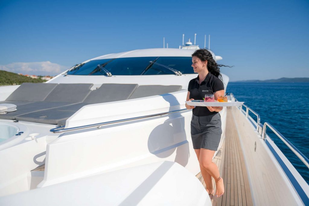 quantum yacht charter stewardess serving drinks