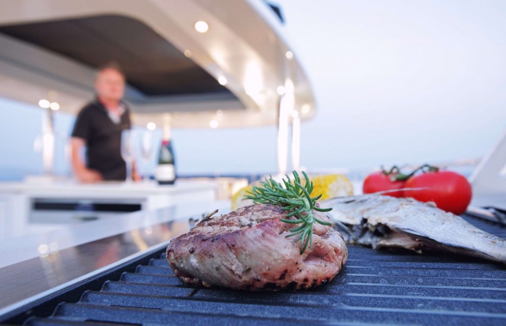 chef by the table with a served dinner