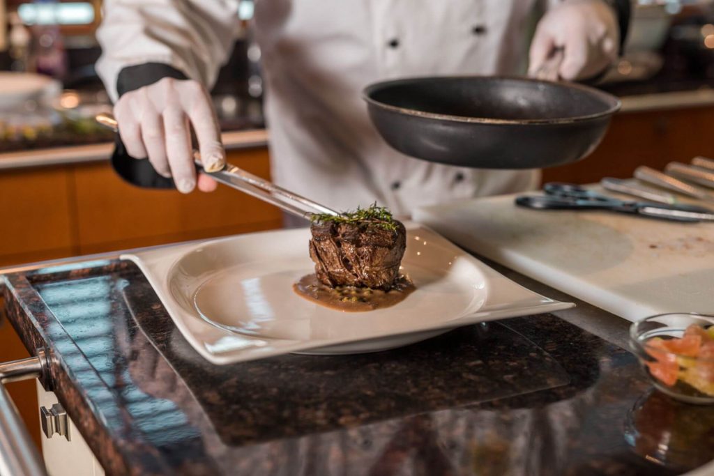 agram yacht chef cooking a meal