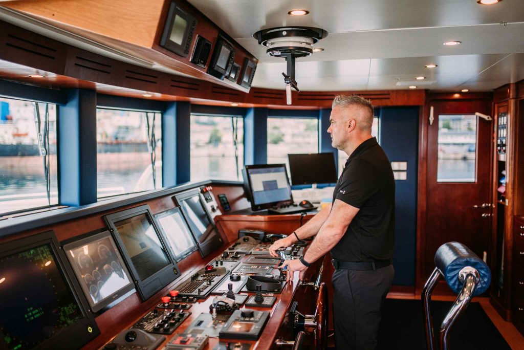 Tirea yacht charter captain on the bridge