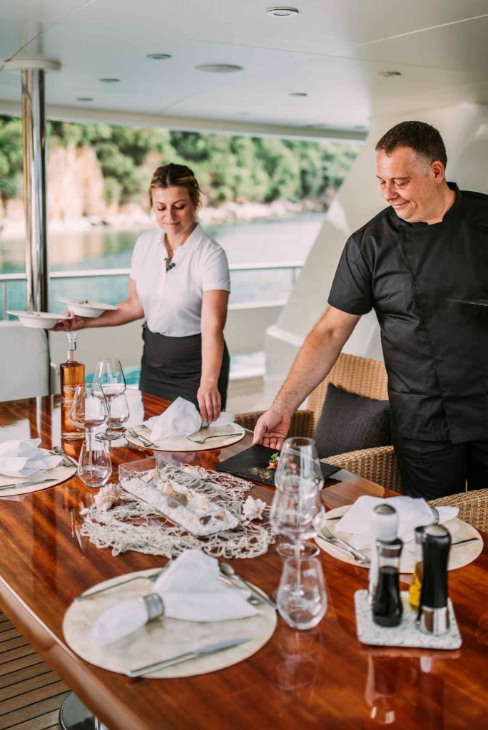 Tirea yacht charter crew serving the table