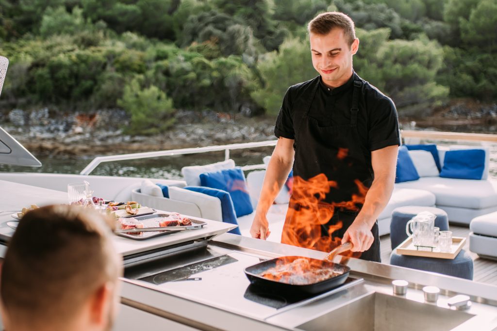 andiamo yacht charter chef preparing flambé dinner