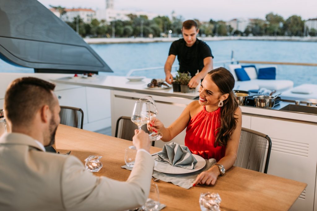 andiamo yacht charter guests toasting with wine