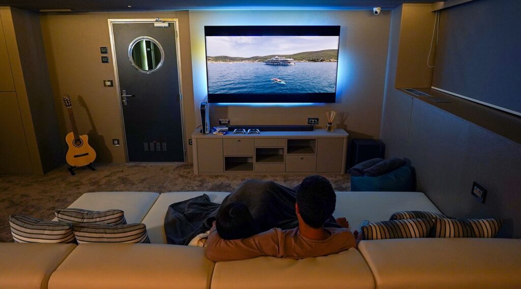 couple watching tv in the yacht cinema room