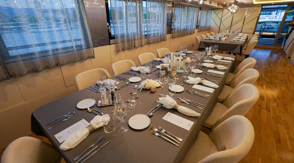 two dining tables with decorations on the yacht upper deck