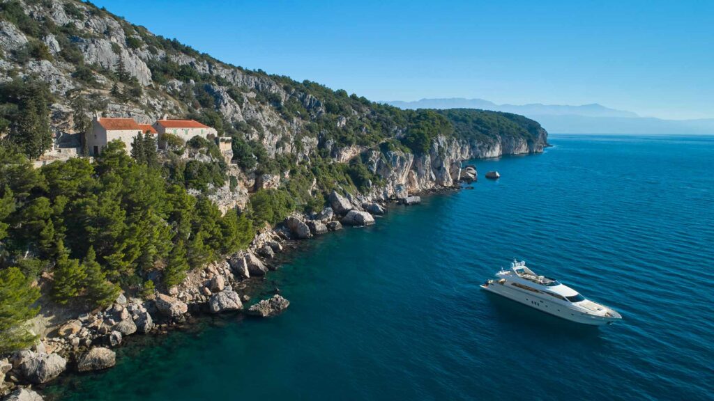 yacht at anchor near an island