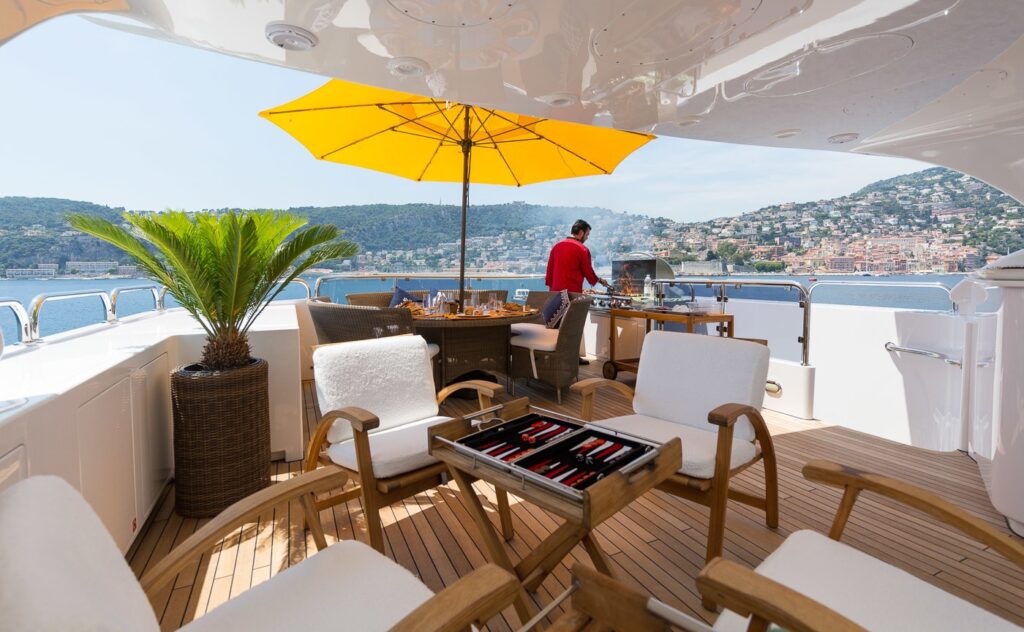 chef preparing food on the bbq onboard yacht sundeck