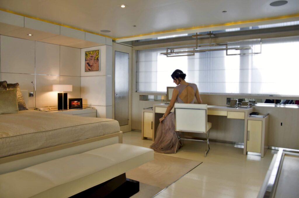 lady sitting on a vanity desk in a yacht cabin