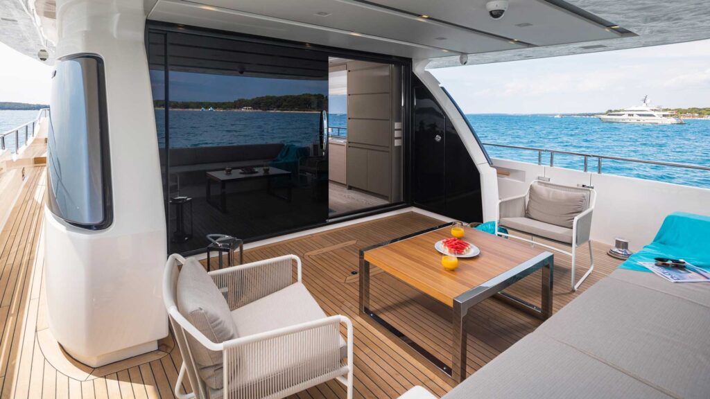 secundus yacht main deck aft, sofa & two chairs, coffee table